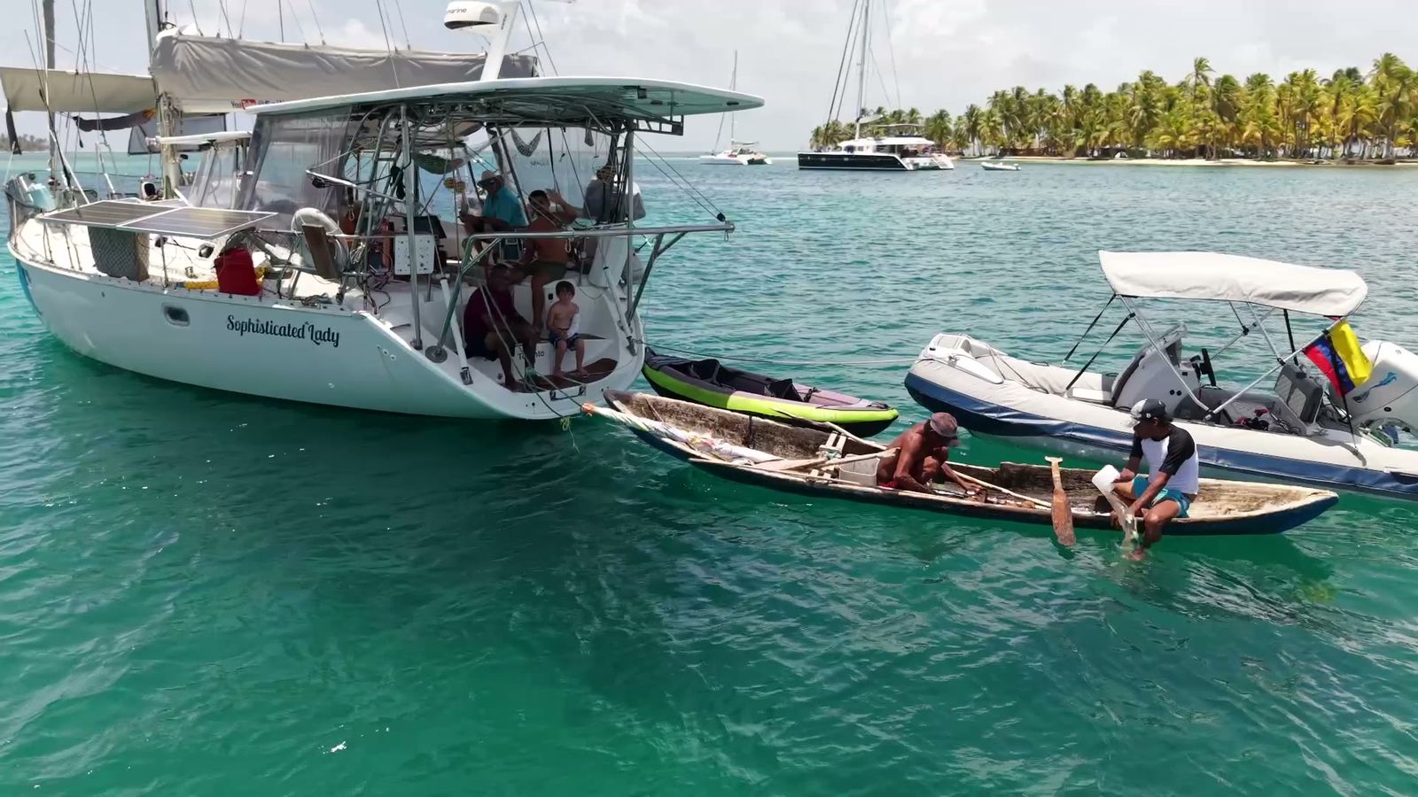 Sophisticated Lady at anchor in San Blas with a Guna canoe and the tender alongside
